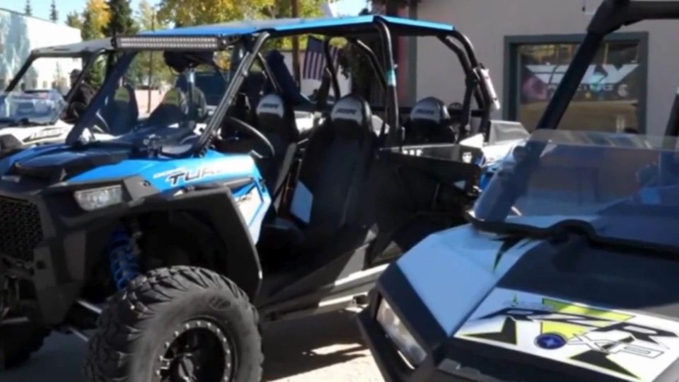 Polaris RZR Turbo side-by-sides parked outside the shop
